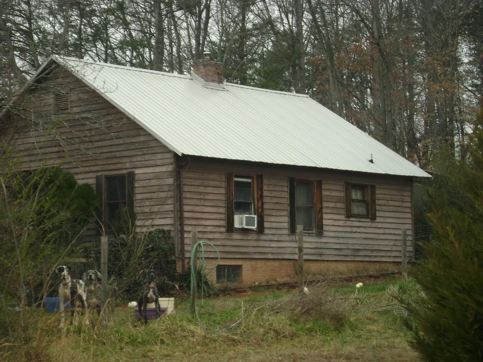White metal roof on an old wood sided farmhouse, from a Metal Roof Installation job in Ixonia